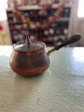 Vintage copper pot with wooden handle and lid
