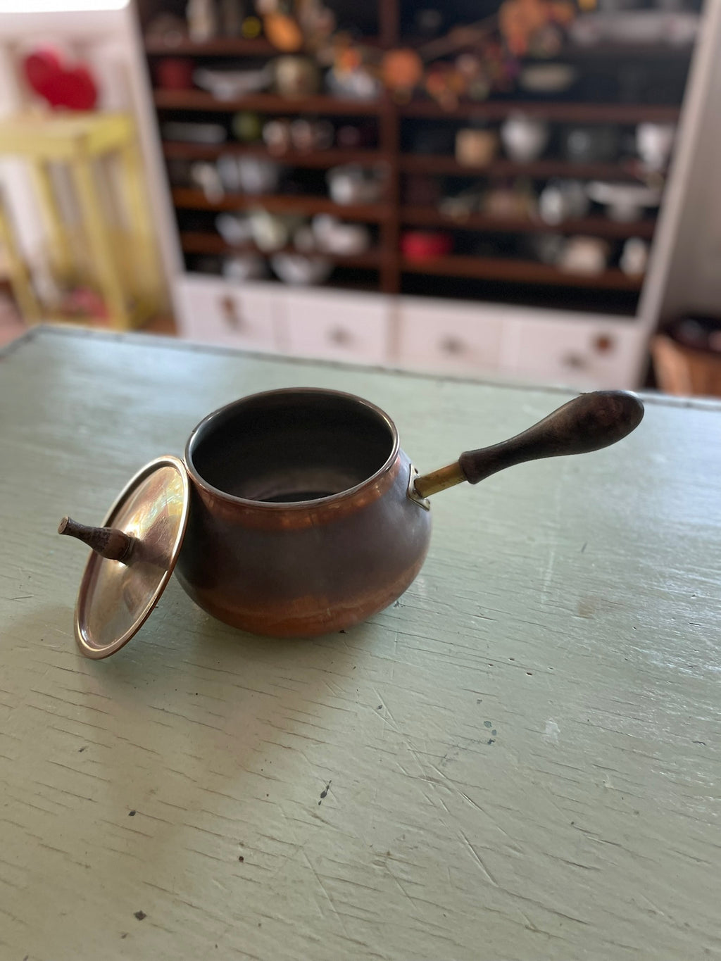 Vintage copper pot with wooden handle and lid