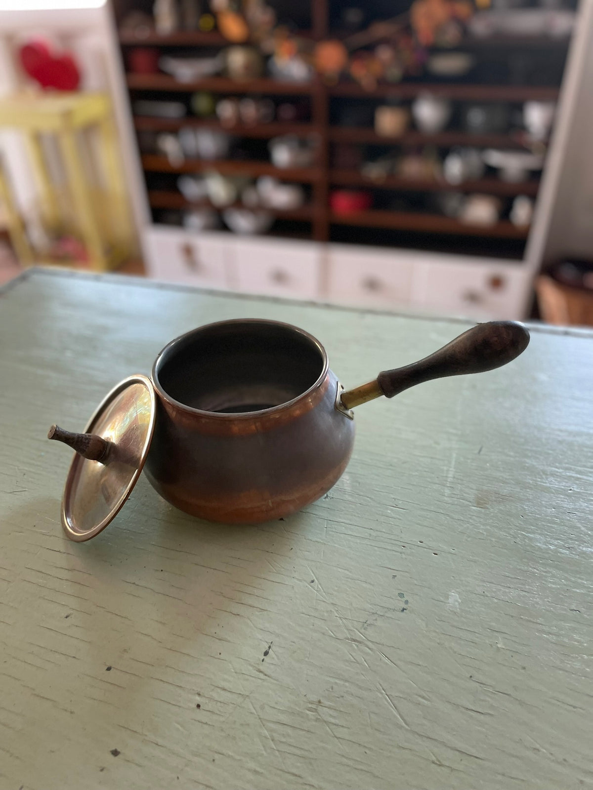 Vintage copper pot with wooden handle and lid