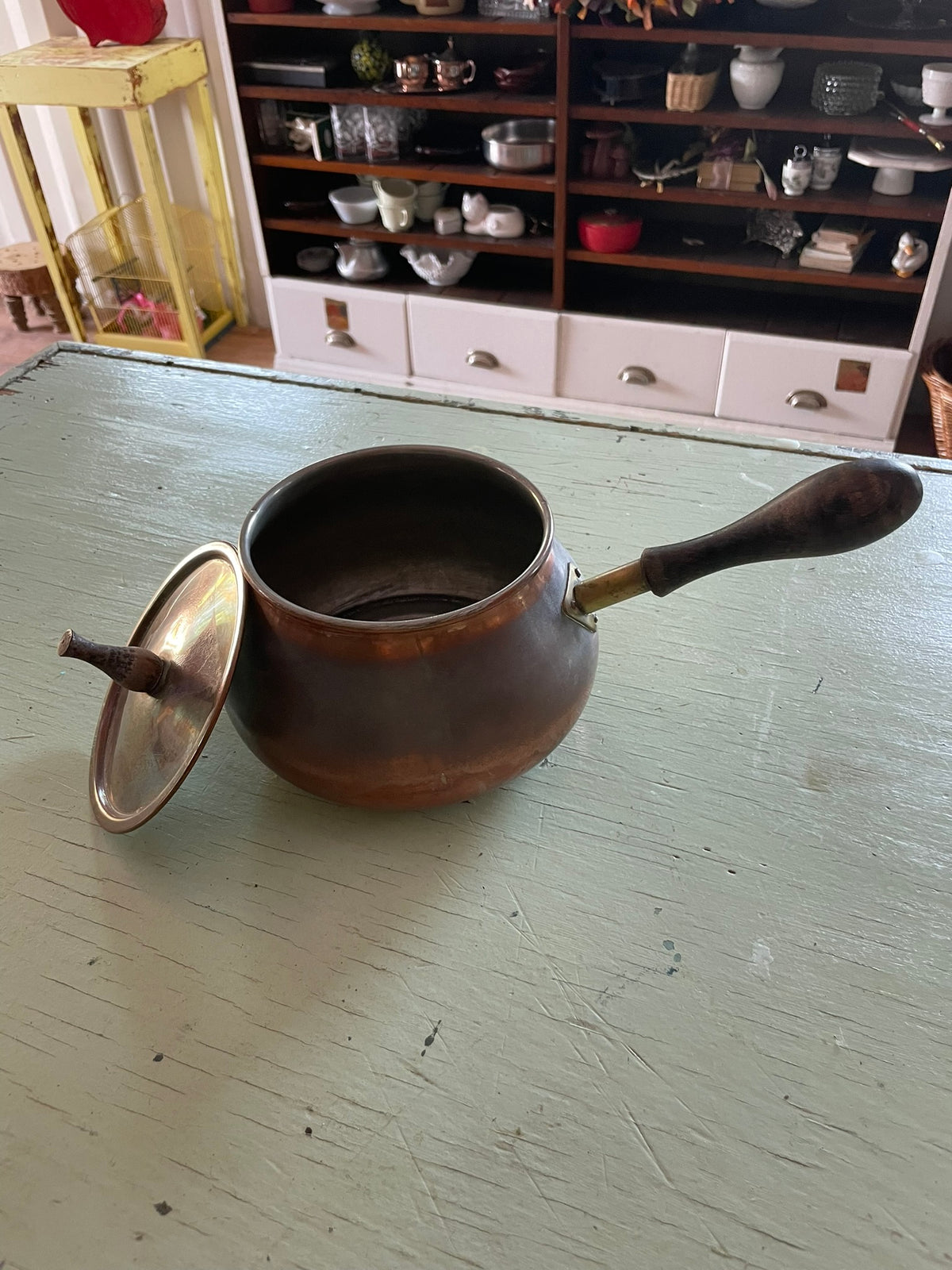Vintage copper pot with wooden handle and lid